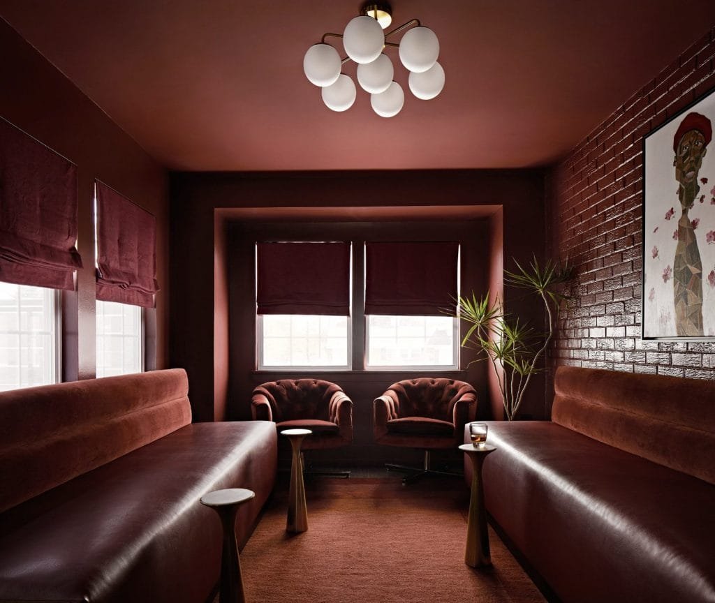 Deep, rich colors and vintage velvet chairs define this dark academic aesthetic from designer Dorian R of Decorilla.