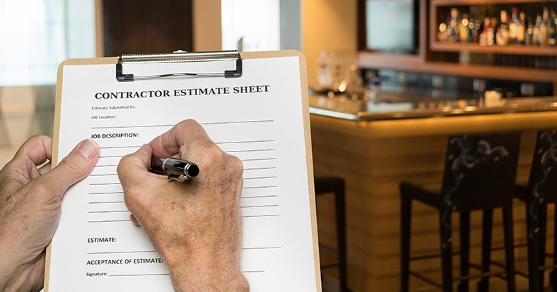 Contractor-filling-out-paper-estimate-by-hand